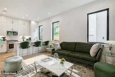 Living room with light wood-style floors and rece