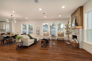The entry opens into the large family room, where a cozy wood-burning fireplace becomes the focal point.