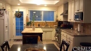 Kitchen and back door leading to garage and patio.