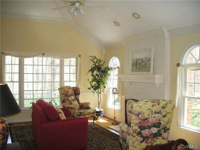 Living room has hardwood floors, vaulted ceiling, 
