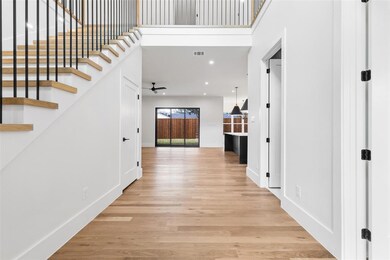 Grand entryway with 21' ceilings and storage close