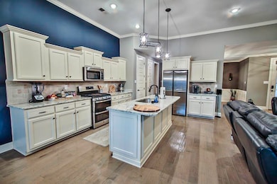 Kitchen featuring visible vents, appliances with s