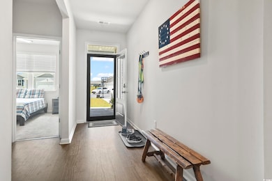 Foyer entrance with dark wood finished floors and baseboards