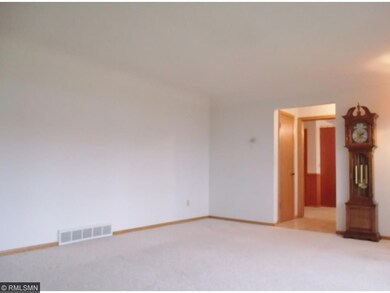 The light-filled living room is a few steps off th