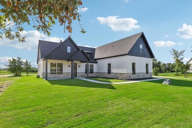 Modern inspired farmhouse featuring a front yard
