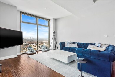 Living area with hardwood / wood-style floors, bas