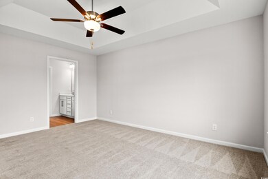 Unfurnished bedroom featuring baseboards, ensuite 