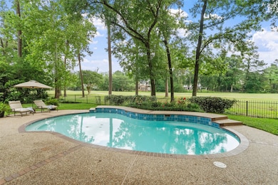 Golf course view backyard features a charming pool
