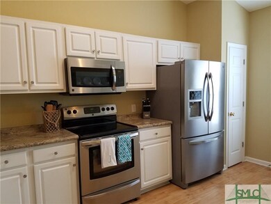 Beautiful white cabinetry with newer stainless app