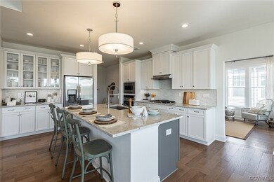 Kitchen featuring a kitchen island with sink, stai