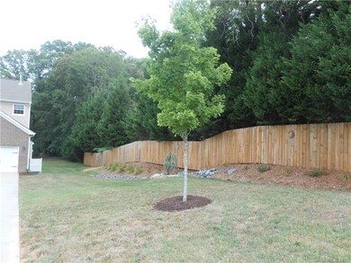 Privacy fence and professional landscaping on right side of home.