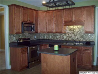 Spacious Kitchen work area offers breakfast bar/is
