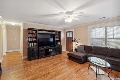 Living area with ornamental molding, a wealth of n