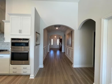 Corridor featuring dark hardwood / wood-style floo