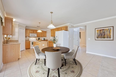 Casual dining open to the kitchen. Virtually Staged.