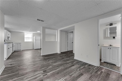 Unfurnished living room with dark wood-type floori