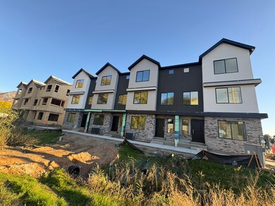 Back of house with brick siding, a patio area, and stucco siding