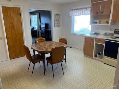 Dining area with brick patterned flooring and baseboards