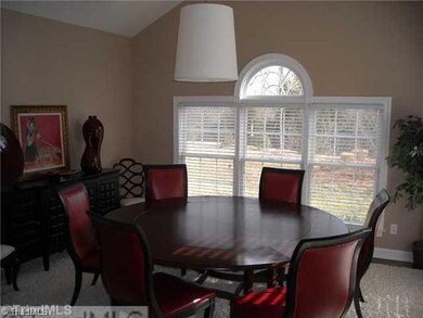 Sunroom. Vaulted sunroom is shown being used as a formal dining room. Cable outlets make it also suitable for casual living space if desired. Atrium doors lead to the patio. Windows overlook the nicely landscaped rear yard and wooded area beyond.
