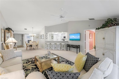 Living room with lofted ceiling, ceiling fan with 