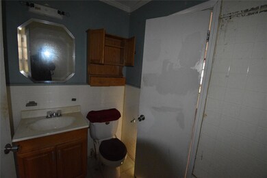 Full bath with tile walls, toilet, ornamental mold
