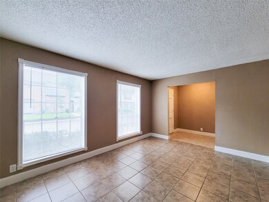 The oversized living room has lots of natural ligh
