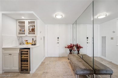 Foyer featuring indoor wet bar, beverage cooler, and visible vents