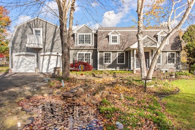 Koi pond with waterfall in front of house