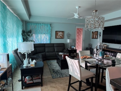 Tiled living room featuring a chandelier