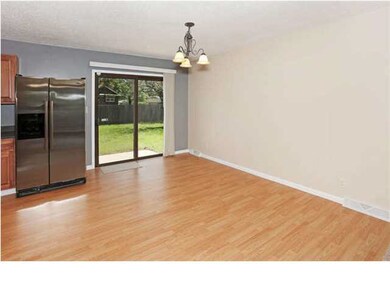 Dining area has wood laminate and sliding doors go