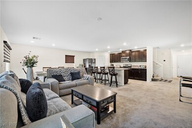 Living room featuring stairs, light carpet, and re