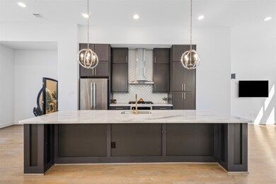 Stylish kitchen featuring elegant light fixtures above the island, adding a touch of sophistication. The perfect blend of function and modern design.