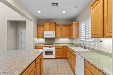 Kitchen featuring recessed lighting, white applian