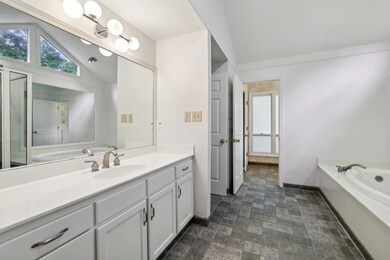 The Main-Level Primary Suite features Double Vanit