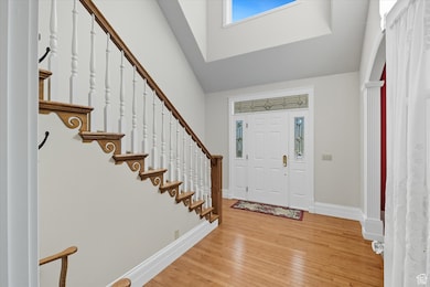 Foyer featuring light wood-style flooring and arched walkways