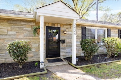 View of exterior entry featuring a shingled roof a
