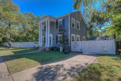 Greek revival inspired property with a front yard