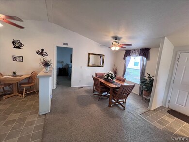 Tiled dining room featuring lofted ceiling and cei