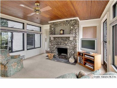 Sunroom with fireplace overlooking rear gardens