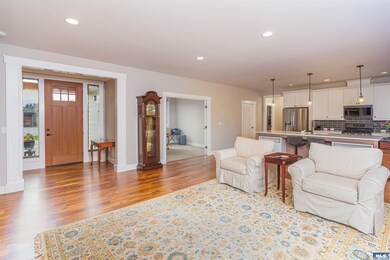 The beautiful front door and entry on the right. Gorgeous hardwood floors; 9' ceilings