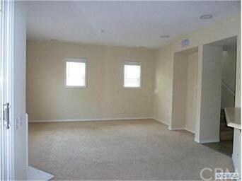Large living room with carpet.