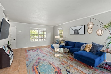 Tiled living area with crown molding