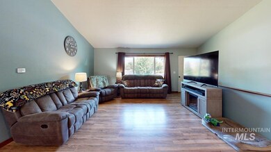 Living room with lofted ceiling and wood finished floors