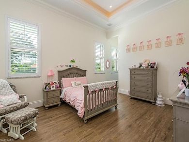 Bedroom with ornamental molding, multiple windows,
