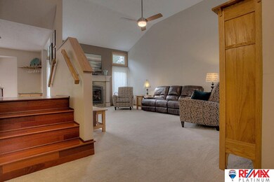 Inviting view from the front entrance. Wall to wall carpet, soaring ceilings, beautiful fireplace
