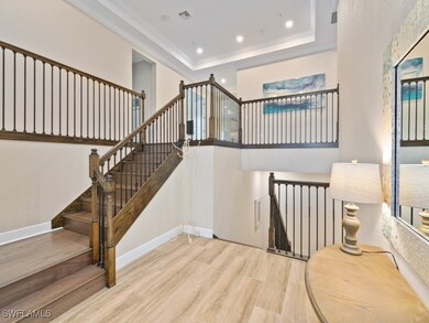 Stairway with wood-type tile, a raised ceiling, an