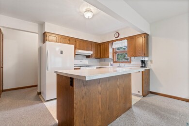 Kitchen with light countertops, white appliances, 