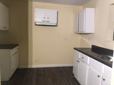 Kitchen with a wall mounted air conditioner, dark 