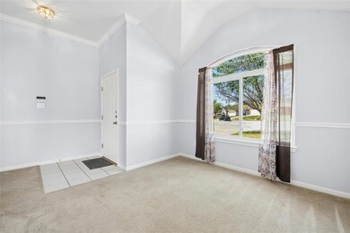 Carpeted entrance foyer with baseboards, vaulted 