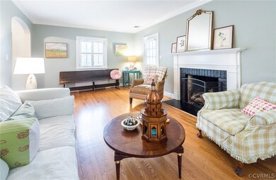 Living room view from the back of the house. Notice the arched doorway and door to side screened porch.